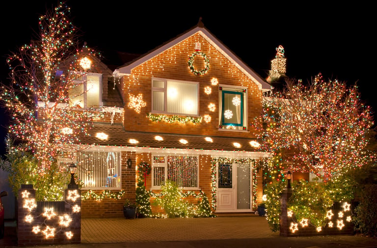 Christmas lights outside on a house and garden