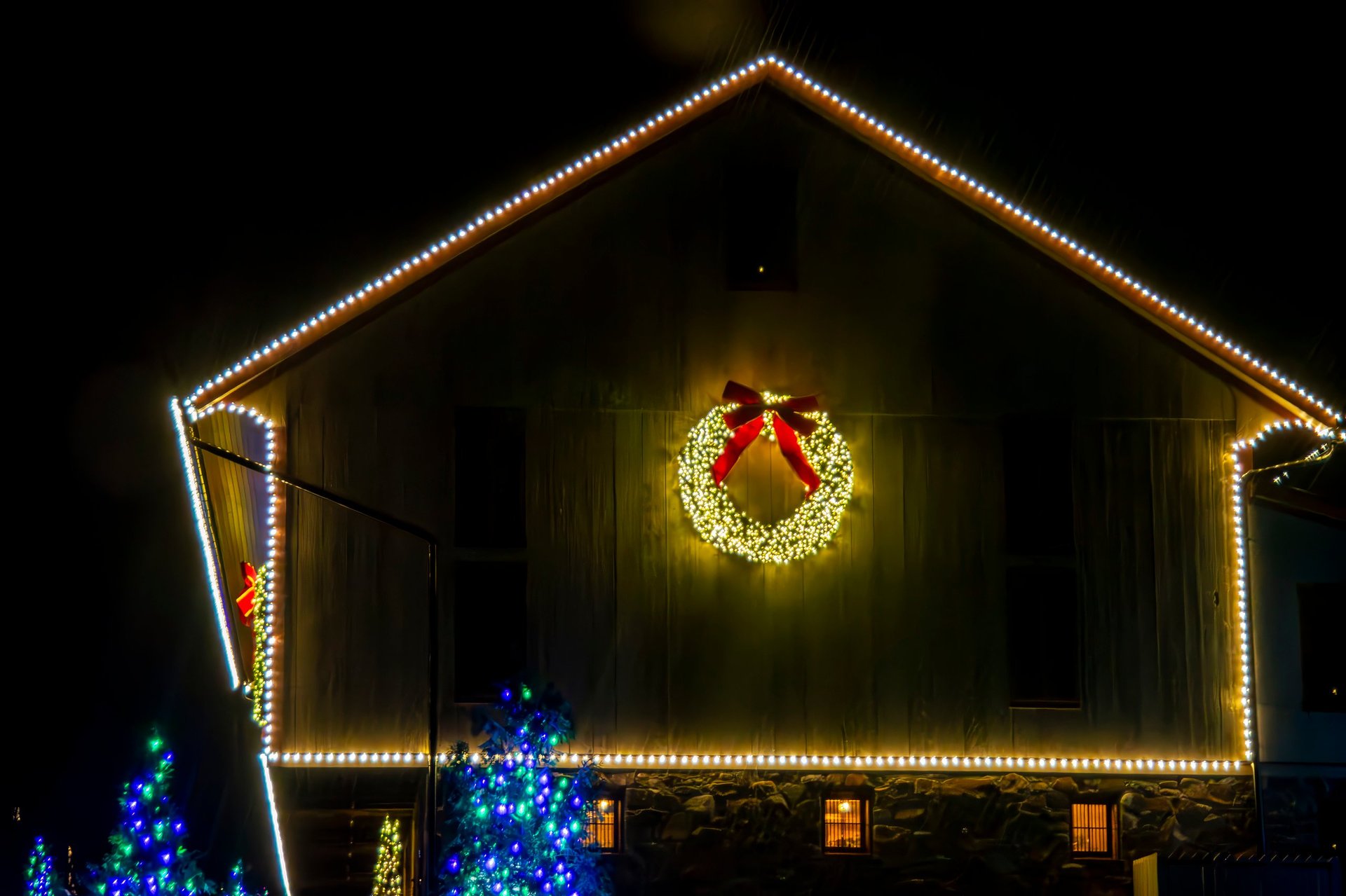 Home with Christmas lights on gable and wreath