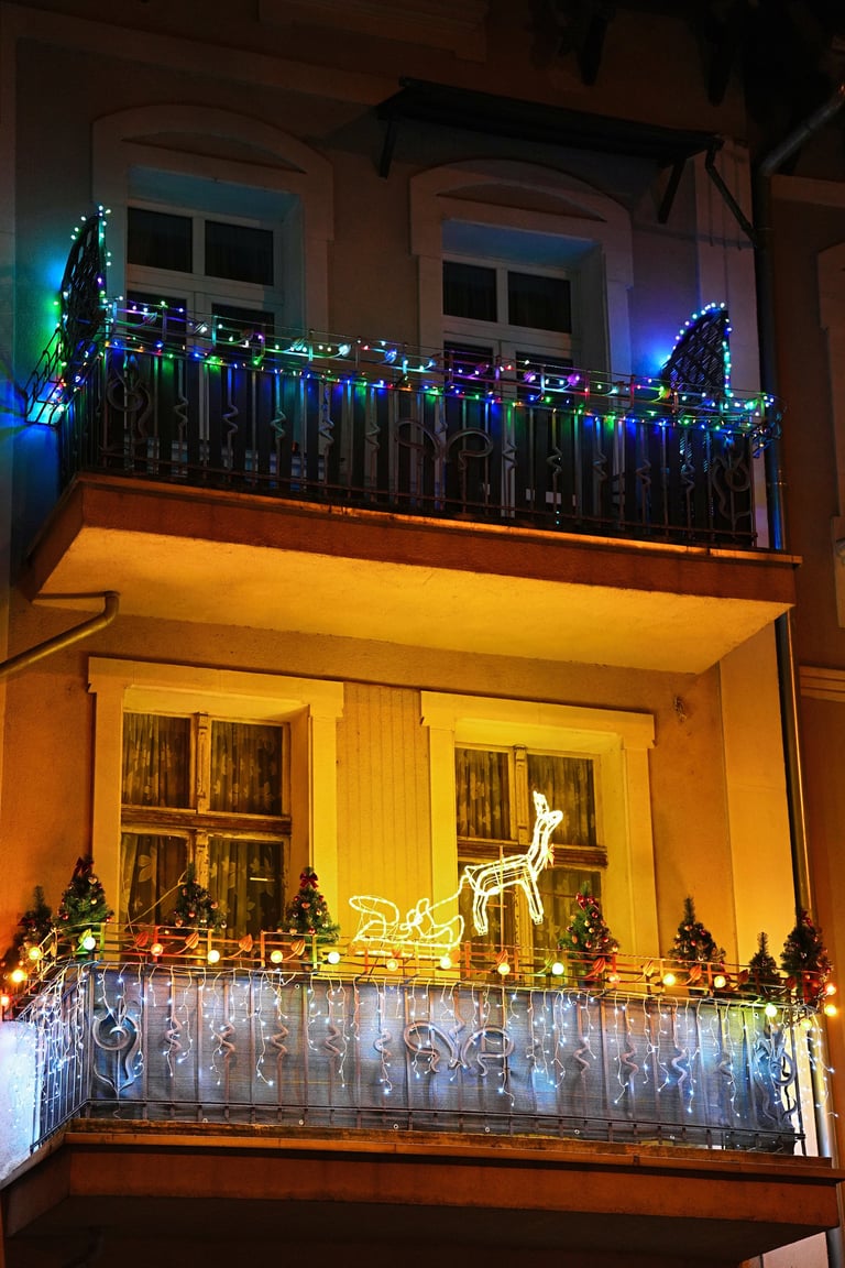 Decorated balconies of apartments with Christmas garlands and lights